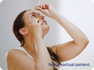 Woman applying prescription eye drops 